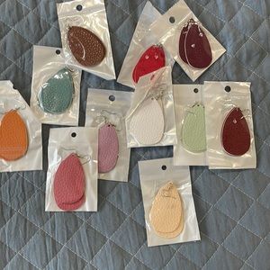 11 Pairs of various colored earrings